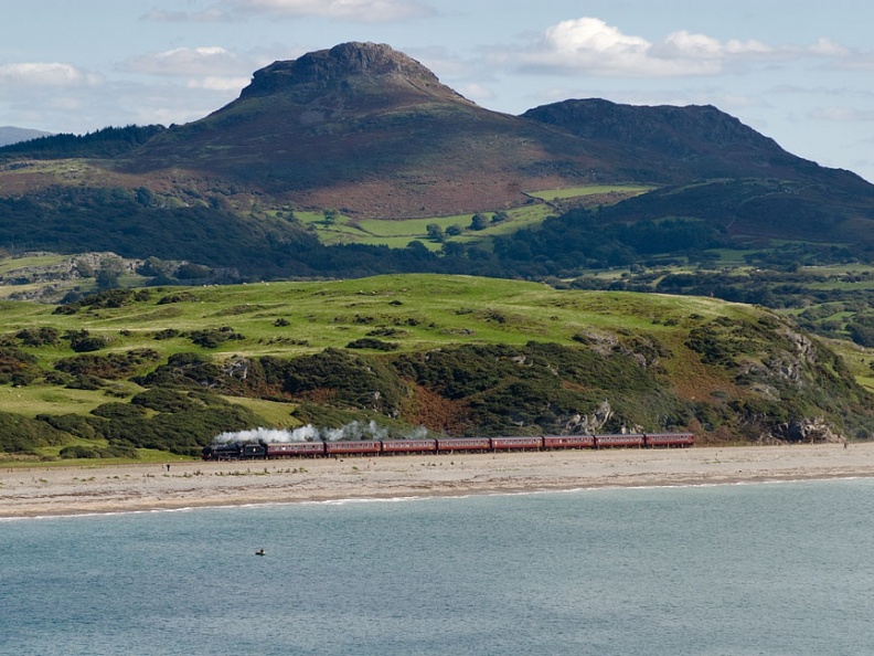 LMS Class 5MT no. 44871 runs past the beach at Criccieth with WCRC's 1J77 “The Cambrian” 10.05 Machynlleth to Pwllheli. flickr-welsh snapper-4942411521.jpg