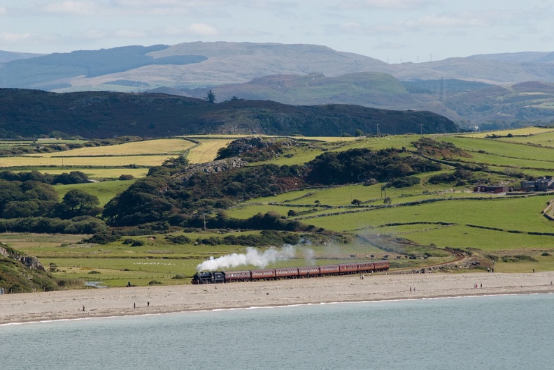 LMS Class 5MT no. 44871 runs past the beach at Criccieth with WCRC's 1J77 “The Cambrian” 10.05 Machynlleth to Pwllheli. flickr-welsh snapper-4942999158.jpg