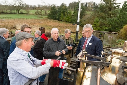 Roger Hine, Rob Houghton, Pete Waterman, and Julian Birley discuss the footplate controls of Quarry Hunslet “Winifred”