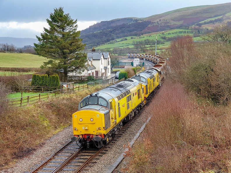 97304 “John Tiley” and 97303 crest the summit t Talerddig on the 6C70 08:52 Crewe Basford Hall to Talerddig, with ballast for the worksite near Machynlleth. flickr-47061324041.jpg